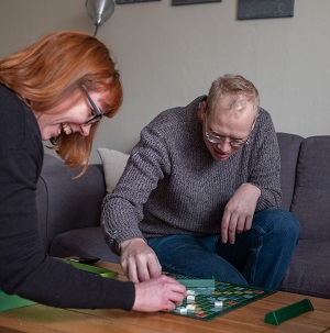 Two people playing a game of scrabble