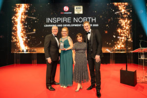 CEO Ruth Kettle and Director of People Donna Gooby accept the Learning and Development Award, with host Dan Walker.